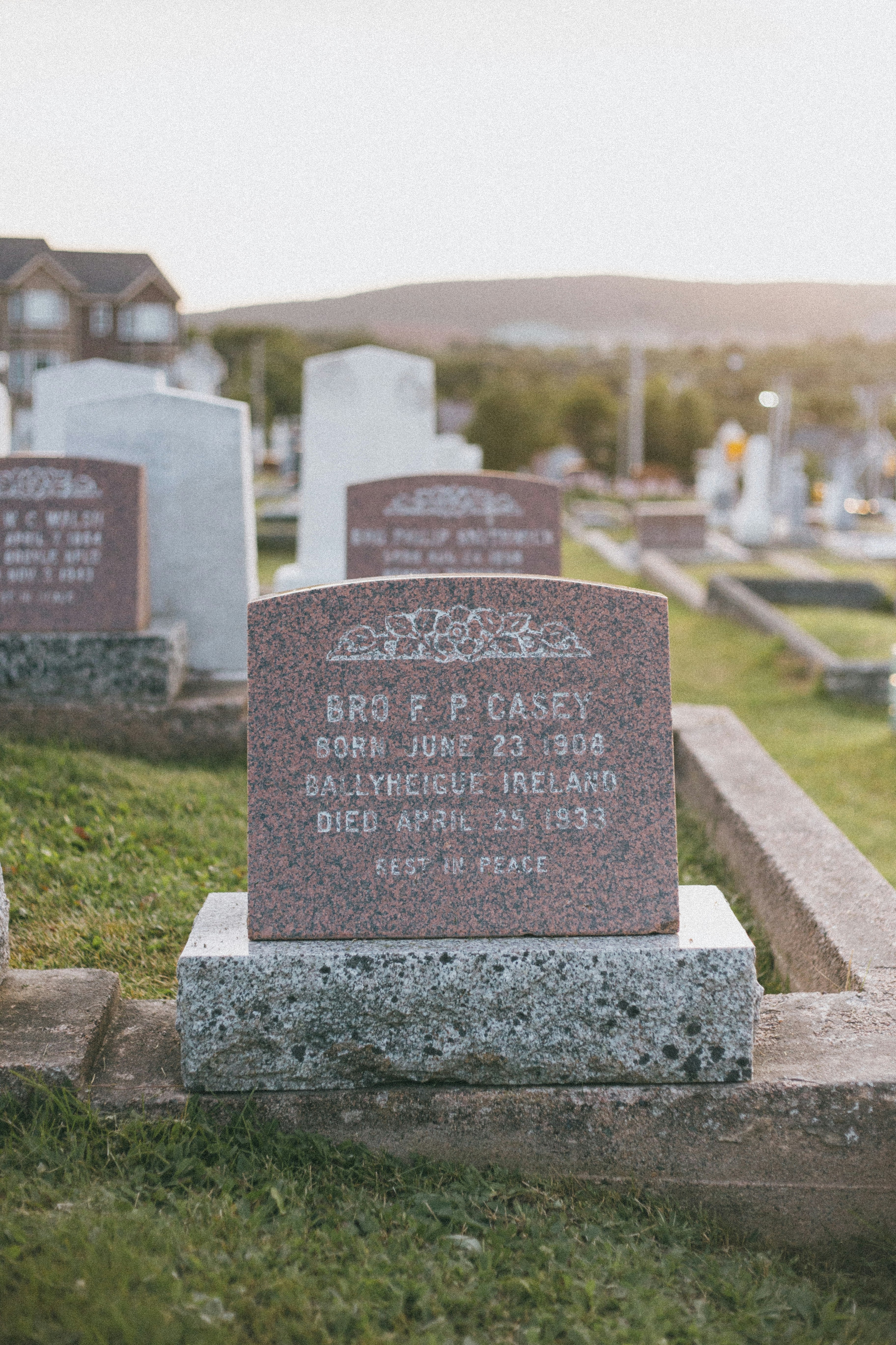 gray tomb stone on green grass field during daytime